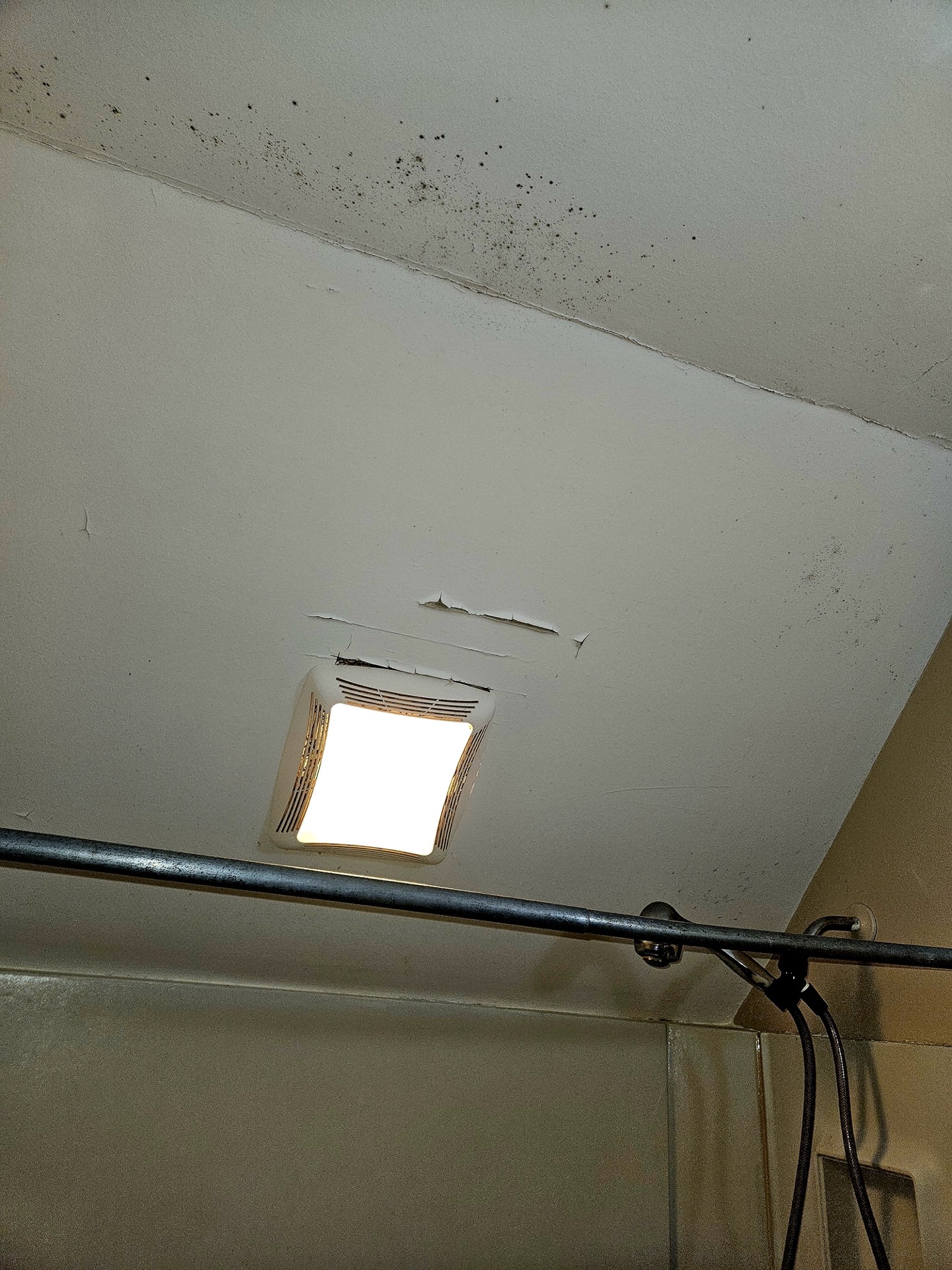 Bathroom wall with water damage before repair